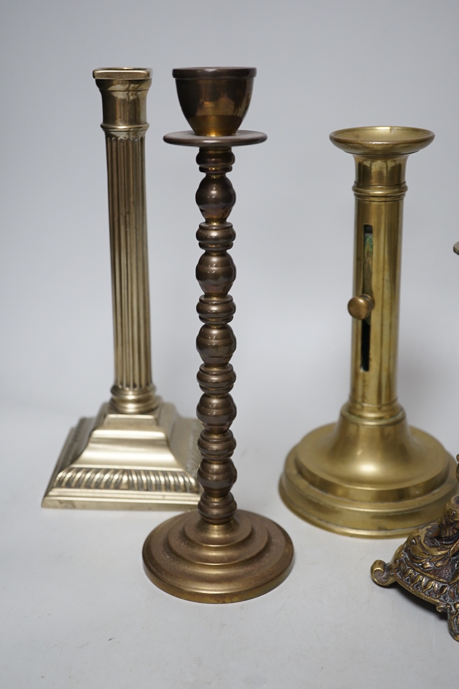 Five various brass candlesticks, tallest 26cms high